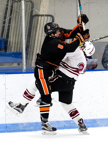 KUA senior F Mike Lombardi (8) plays the body. He also played the puck, scoring 2 goals (including an empty-netter) and adding an assist to lead the W