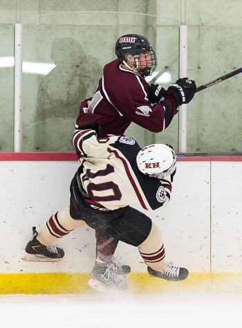 Dexter's Kevin Hock attempts to squeeze past Clay Ellerbruck of Kents Hill Wed. Jan. 20.