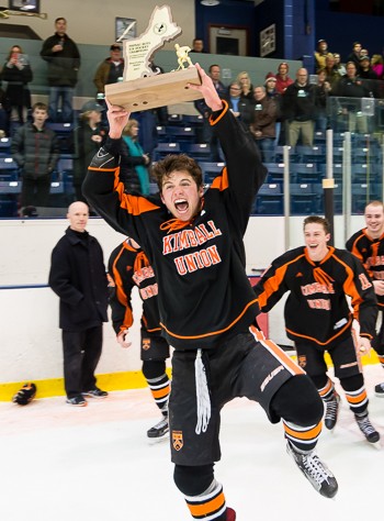 KUA senior forward Mike Lombardi hoists the hardware.